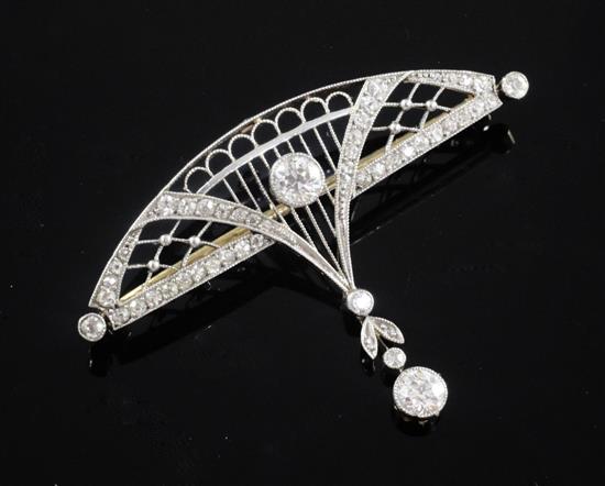 A Belle Epoque gold, platinum and diamond set openwork demi lune drop brooch, 46mm.